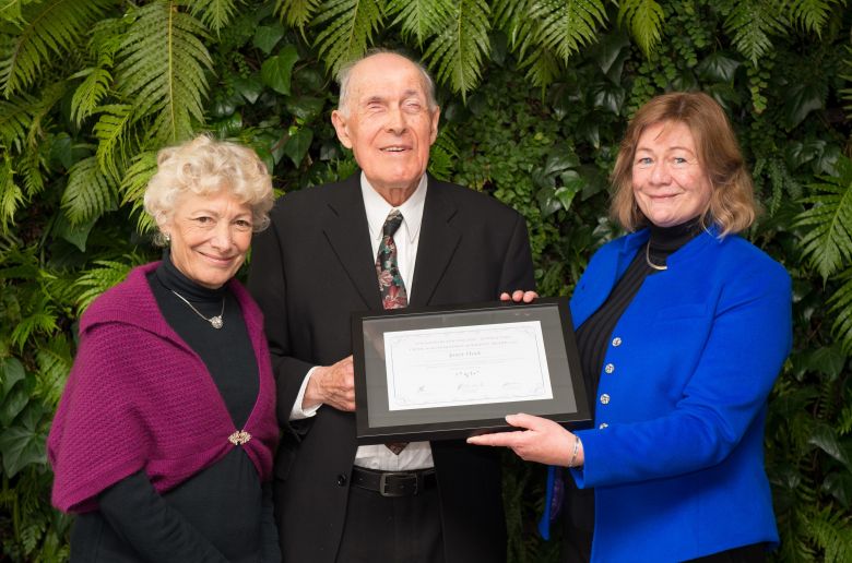 Professor Janet Hoek receiving her award from The Game Foundation's Grant and Marilyn Nelson